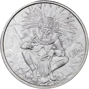 An embossed metallic coin featuring a seated figure in an elaborate Aztec or Mayan headdress and attire, surrounded by stonework detail and skulls.