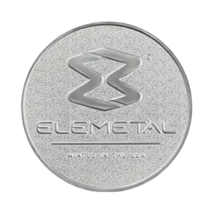 A silver coin with a raised stylized ""E"" logo and the words ""ELEMETAL"" and ""MADE IN THE USA"" embossed below.