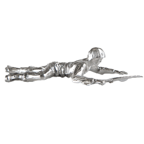 Metal figurine of a person lying prone, holding a long object.